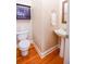 Small powder room with pedestal sink and hardwood floors at 160 Edgewater Trl, Fayetteville, GA 30215