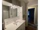 Bathroom with updated vanity and access to another room at 1885 Broad Ave, East Point, GA 30344
