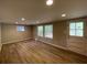 Bright living room with hardwood floors and large windows at 1885 Broad Ave, East Point, GA 30344