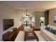 Bright living room with hardwood floors, a neutral color palette, and access to the kitchen and dining area at 5914 Sara Ashley Ct, Lithonia, GA 30058