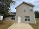 Two-story house with vinyl siding, a patio, and a yard at 3063 Stonebridge Creek Dr, Lithonia, GA 30058