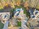Stunning aerial view of a home with a private pool surrounded by lush greenery and mature trees at 424 Lake Point Trce, Canton, GA 30114