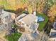 Aerial view of a brick home with a large backyard, swimming pool, and surrounding trees at 424 Lake Point Trce, Canton, GA 30114