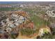 Expansive aerial view of a neighborhood, highlighting tree coverage, golf course, and quiet streets at 424 Lake Point Trce, Canton, GA 30114
