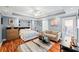 Cozy bedroom with a queen bed, sitting area, stylish decor, and access to an outdoor space at 424 Lake Point Trce, Canton, GA 30114