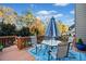 Outdoor deck featuring a dining set, umbrella, and a view of the surrounding trees and landscape at 424 Lake Point Trce, Canton, GA 30114