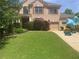 Well-manicured lawn of this charming two-story brick home with a two-car garage at 424 Lake Point Trce, Canton, GA 30114