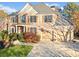 Charming two-story brick home with a well-maintained yard, mature trees, and a spacious driveway at 424 Lake Point Trce, Canton, GA 30114