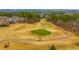 Aerial view of a meticulously maintained golf course featuring lush green fairways, sand traps, and mature trees at 424 Lake Point Trce, Canton, GA 30114
