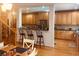 Spacious kitchen featuring light wood cabinetry, an island with seating, and hardwood floors at 424 Lake Point Trce, Canton, GA 30114