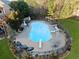 In-ground pool surrounded by lush landscaping, including a diving board, slide, and outdoor seating at 424 Lake Point Trce, Canton, GA 30114