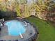 A large pool with a slide and diving board is surrounded by outdoor furniture and lush landscaping at 424 Lake Point Trce, Canton, GA 30114