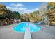 Inviting backyard pool with a diving board, slide, lounge chairs, and lush greenery at 424 Lake Point Trce, Canton, GA 30114