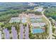 Aerial view of multiple outdoor tennis courts with lush green surroundings, a parking lot, and a view of the neighborhood at 424 Lake Point Trce, Canton, GA 30114
