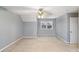 Bedroom with neutral carpet, ceiling fan, gray walls, and bright window at 75 Crestview Dr, Dallas, GA 30157