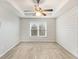 Main bedroom with tray ceilings, a ceiling fan and shiplap accent wall at 75 Crestview Dr, Dallas, GA 30157