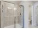 Modern bathroom with a large walk-in shower and neutral tile at 214 Wilder Ridge Way, Lawrenceville, GA 30044