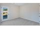Bright bedroom with grey carpet, door to outside, and ample natural light at 214 Wilder Ridge Way, Lawrenceville, GA 30044