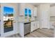 Kitchen features white cabinets, granite countertops, and a door leading to a deck at 214 Wilder Ridge Way, Lawrenceville, GA 30044
