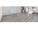 Open concept living area with grey vinyl plank flooring at 214 Wilder Ridge Way, Lawrenceville, GA 30044