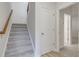 Carpeted staircase with wooden handrail in a hallway at 214 Wilder Ridge Way, Lawrenceville, GA 30044