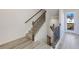 Modern staircase with wood railing and neutral carpeting at 214 Wilder Ridge Way, Lawrenceville, GA 30044