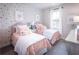 Charming bedroom with twin beds, colorful polka dot wallpaper and bright window at 723 Crossroad Ct, Powder Springs, GA 30127