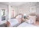 Bright bedroom with twin beds, colorful polka dot wallpaper and bright window at 723 Crossroad Ct, Powder Springs, GA 30127