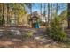 Community playground with a swing set, slide, and climbing structure, nestled among trees at 6640 Maid Marion Close, Alpharetta, GA 30005