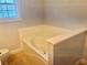 Bathroom featuring a bathtub with deck and tile floor, perfect for relaxation at 815 Sylvan Dr, Marietta, GA 30066