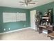 Bedroom with neutral carpet, ceiling fan, and white board, perfect for a study or guest room at 815 Sylvan Dr, Marietta, GA 30066
