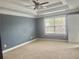 Bedroom with neutral carpet, ceiling fan and lots of natural light, creating a comfortable space at 815 Sylvan Dr, Marietta, GA 30066