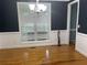 Formal dining room with hardwood floors, wainscoting, and elegant chandelier at 815 Sylvan Dr, Marietta, GA 30066