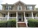 Charming two-story home featuring a stone accent, a welcoming front porch, and lush landscaping at 815 Sylvan Dr, Marietta, GA 30066