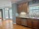 Functional kitchen with wooden cabinets, stainless steel dishwasher, and hardwood floors at 815 Sylvan Dr, Marietta, GA 30066