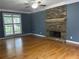 Spacious living room with hardwood floors, a stone fireplace, and large windows at 815 Sylvan Dr, Marietta, GA 30066