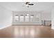 Large bonus room with hardwood floors and multiple windows at 320 Gray Shingle Ln, Woodstock, GA 30189