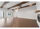 Living room with hardwood floors, exposed beams, and sliding glass doors at 320 Gray Shingle Ln, Woodstock, GA 30189