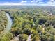 Breathtaking aerial view showcases the neighborhood, surrounded by lush trees and a winding river at 7300 Chattahoochee Bluff Dr, Atlanta, GA 30350