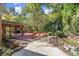 Expansive backyard featuring a spacious deck, lush landscaping, and a charming patio area at 7300 Chattahoochee Bluff Dr, Atlanta, GA 30350