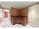 A stylish basement bar area featuring custom cabinetry, neutral paint and tile flooring at 7300 Chattahoochee Bluff Dr, Atlanta, GA 30350