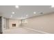 Finished basement featuring neutral colors, a fireplace, and walkout doors at 7300 Chattahoochee Bluff Dr, Atlanta, GA 30350