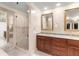 Elegant bathroom features marble countertops, dual sinks, wood cabinetry, and a glass shower for a spa-like experience at 7300 Chattahoochee Bluff Dr, Atlanta, GA 30350