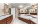 Elegant bathroom features marble countertops, dual sinks, wood cabinetry, and a soaking tub for a spa-like experience at 7300 Chattahoochee Bluff Dr, Atlanta, GA 30350