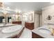 Luxurious bathroom boasts marble countertops, dual sinks, a soaking tub, and elegant fixtures, creating a spa-like oasis at 7300 Chattahoochee Bluff Dr, Atlanta, GA 30350