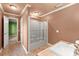 Bathroom area featuring a bathtub, sliding glass door and a view of the doorway to an adjacent bedroom at 7300 Chattahoochee Bluff Dr, Atlanta, GA 30350