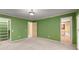 Bedroom with green walls, light carpeting, large closets and an open doorway to an adjacent bathroom at 7300 Chattahoochee Bluff Dr, Atlanta, GA 30350