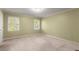 This bedroom has neutral walls and carpet, with two windows that let in plenty of natural light at 7300 Chattahoochee Bluff Dr, Atlanta, GA 30350