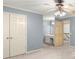 Spacious bedroom featuring light blue walls, a ceiling fan with a light, and access to the bathroom and staircase at 7300 Chattahoochee Bluff Dr, Atlanta, GA 30350