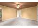Spacious bedroom with tan colored walls and a view of an attached bathroom, light-colored carpet and crown molding at 7300 Chattahoochee Bluff Dr, Atlanta, GA 30350